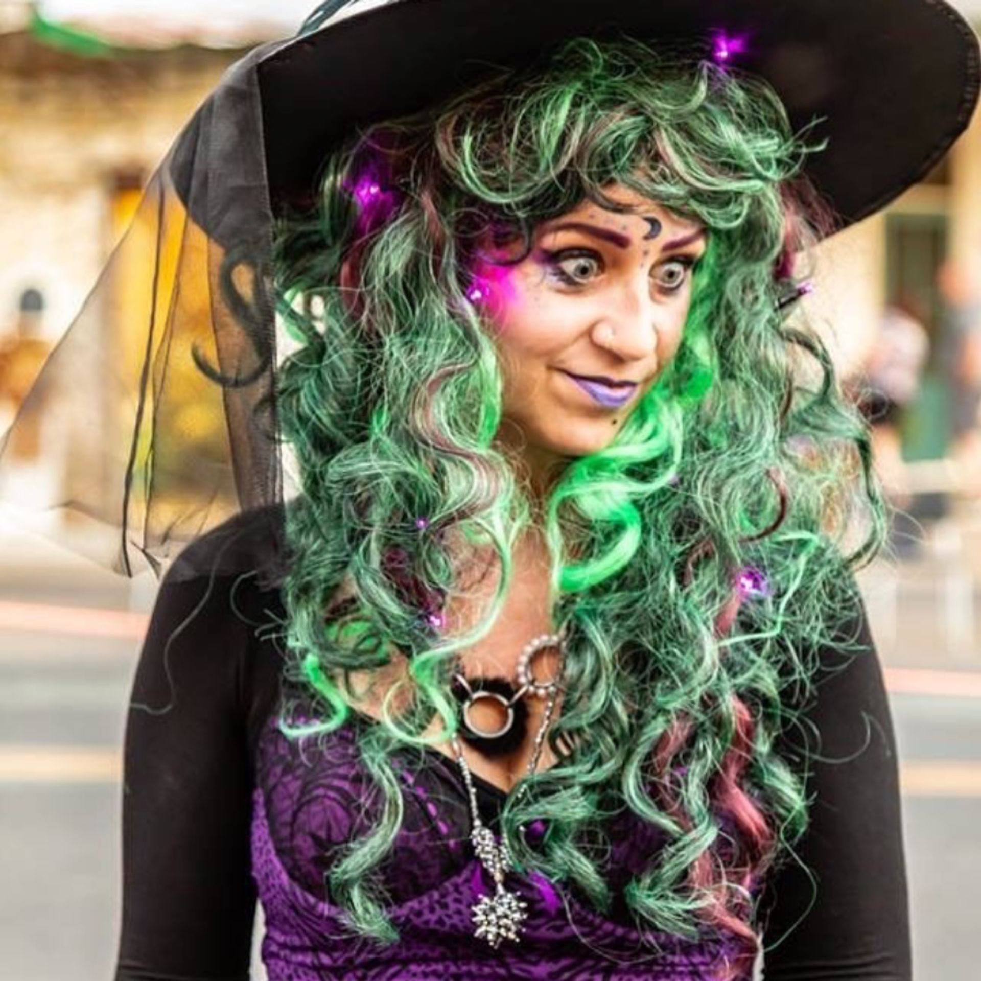 Woman in a costume with a green wig at the Murphys Witch Walk